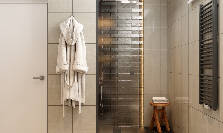 1 bhk bathroom design with beige wall tiles and stone cladding walls, creating a striking contrast.