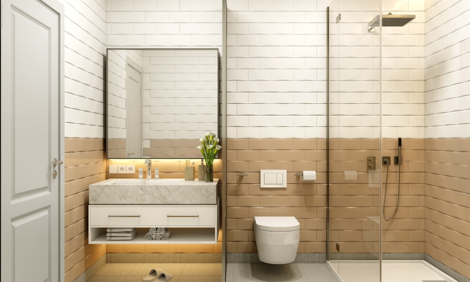1 bhk bathroom design with wall tiles, a vanity and a transparent glass partition, brings a modern look to the space