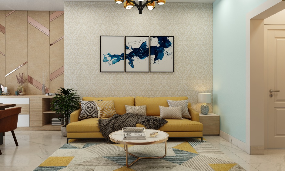 1bhk home design with yellow sofa and dull gold wallpaper