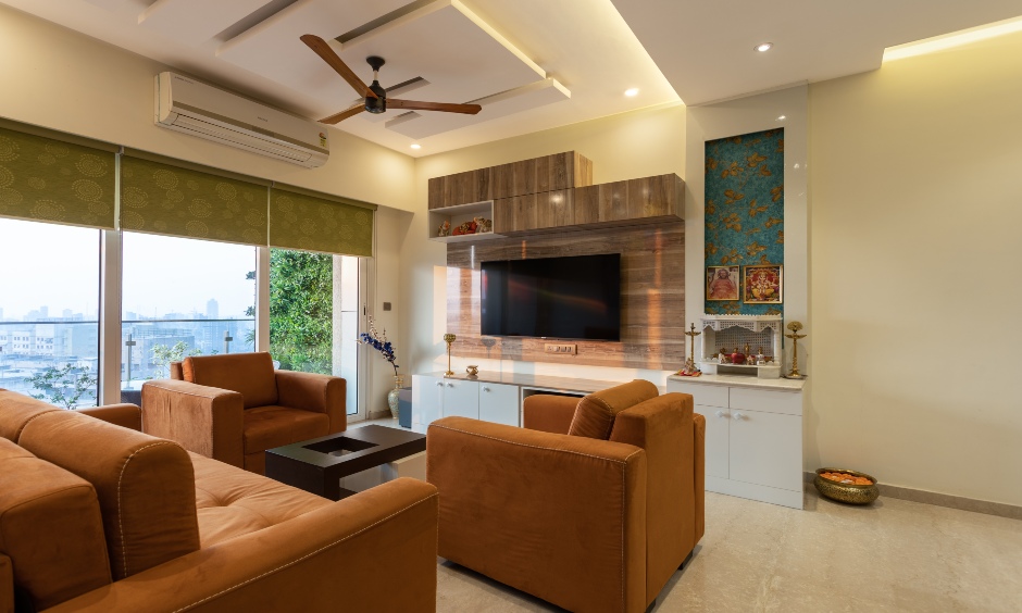 2 bhk house living room interior with TV unit that extends into a pooja unit designed in Mumbai
