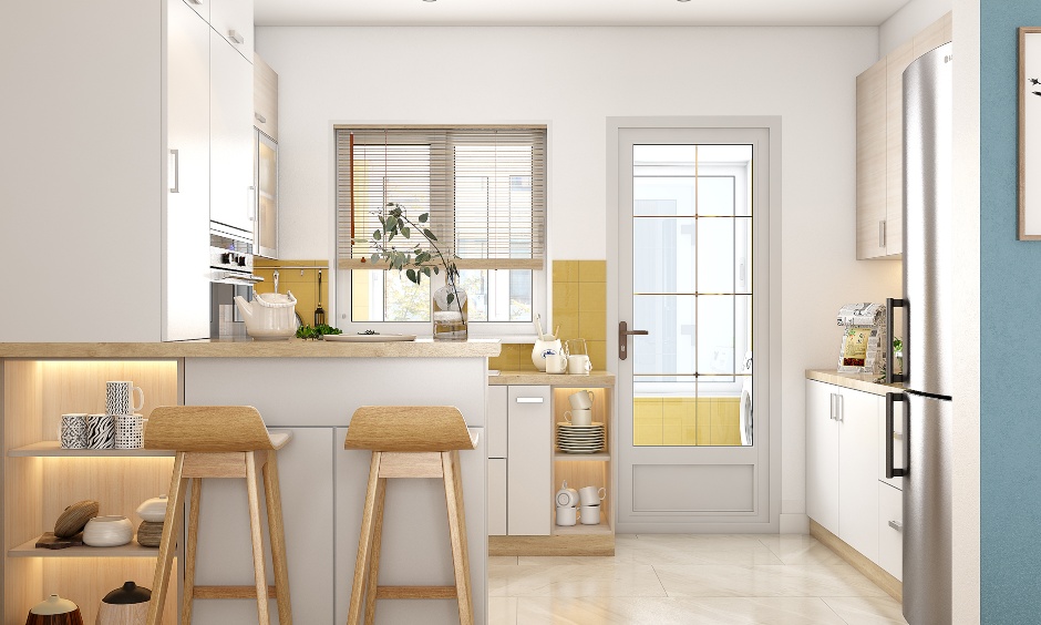 2bhk g shaped kitchen has a breakfast countertop and two tall wooden stools.