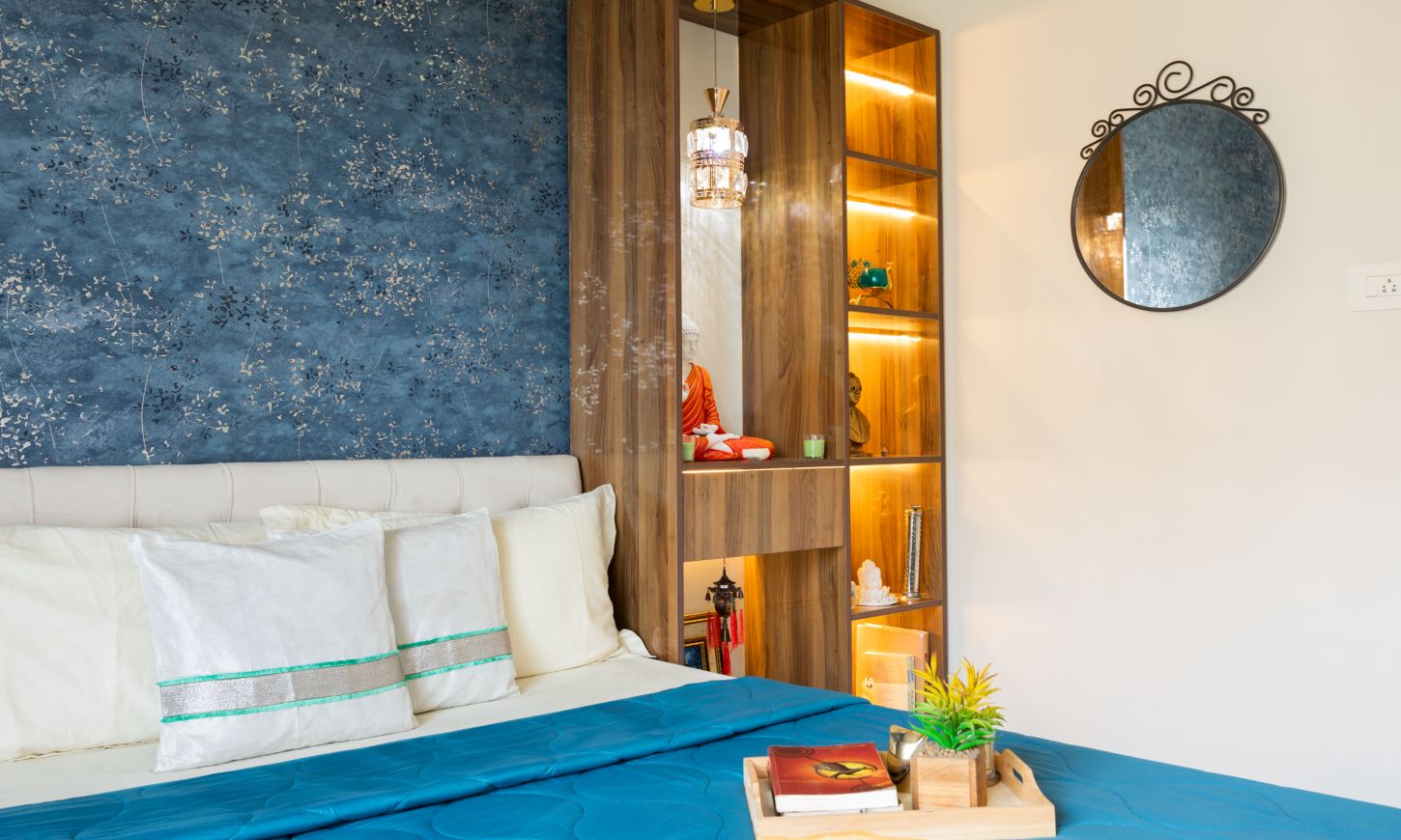 Designcafe designed the master bedroom in Rustomjee Urbania Azziano's 2 bhk apartment in Thane with a bookshelf