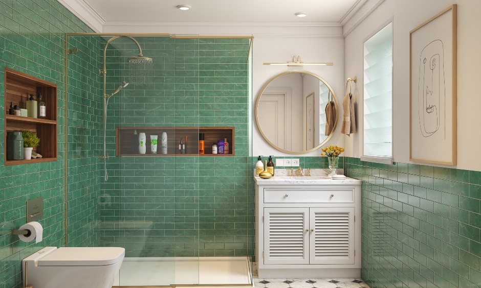 3bhk bathroom design has a green brick-wall cladding with a golden round mirror and a classic white vanity unit.