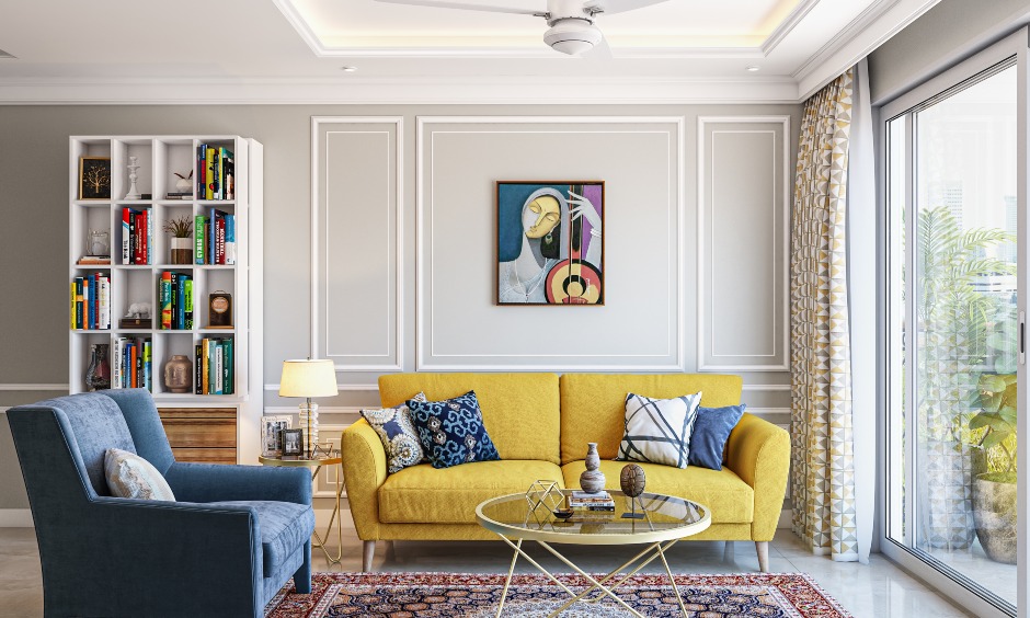 3bhk living room designed with peppy upholstered furniture and open bookshelf brings an elegant look