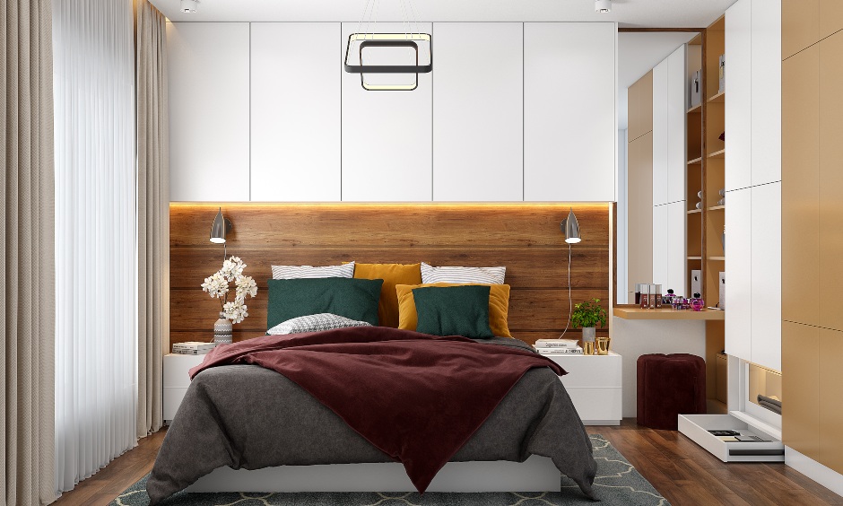 A floor-to-ceiling wardrobe, open shelves and a dresser unit in a 3bhk duplex interior design