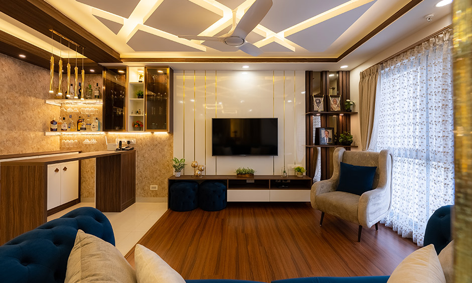 A living room with a bar counter in a 3BHK