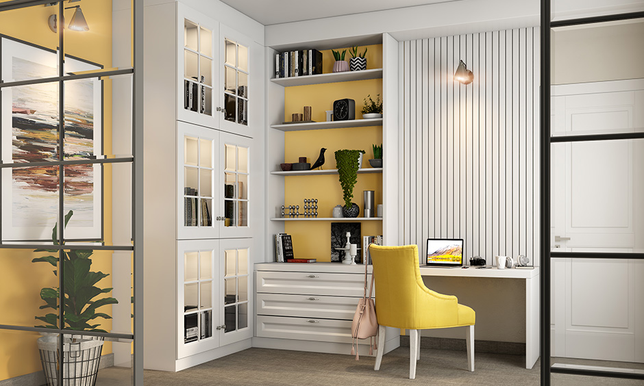 A white charming study room idea with a mirrored cabinet in white and a built-in unit with ledge shelves and drawers
