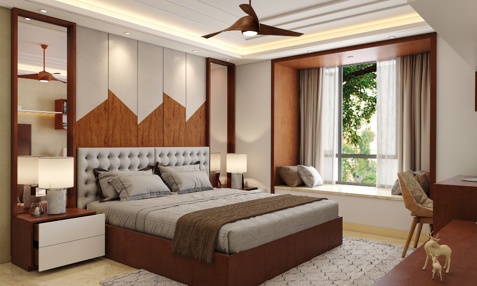 Bedroom design with window bay seating and wooden laminate finished bed with a padded cushion headboard