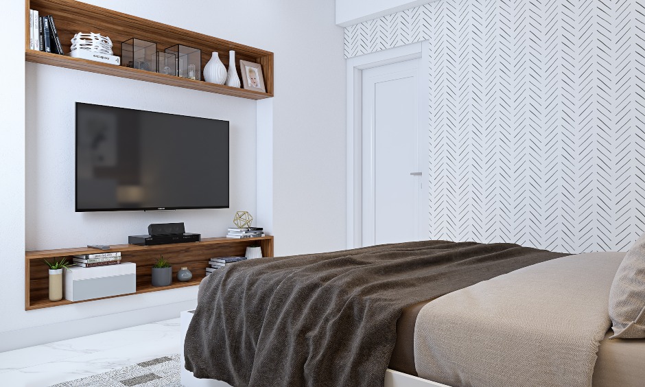 white bedroom with tv unit and floating wooden shelf in 3bhk home interior design in india