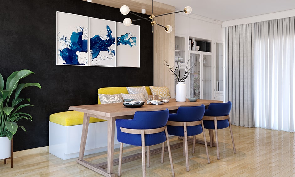 Dining hall colour combinations with black color wall, blue chairs and yellow decor