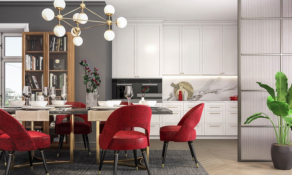 Dining room color combination with red chairs, white cabinetry and grey display wall