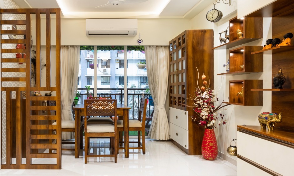 Dining room has a sleek wooden rectangular table with chairs interior company in mumbai