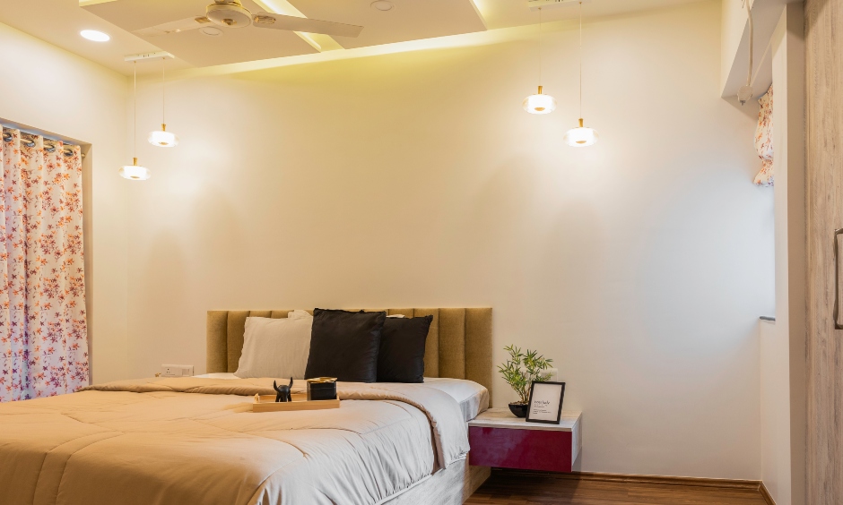 Guest bedroom comes with an intricate false ceiling, cove lights and beautiful pendant lights designed by top architects and interior designers in mumbai