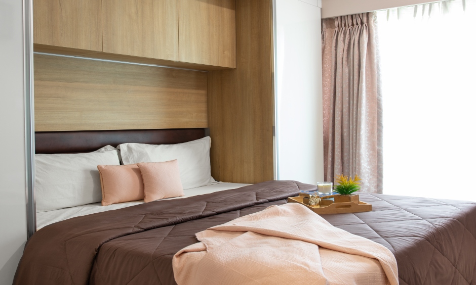 High end interior designers in mumbai master bedroom is designed with wooden panelling and modular wardrobe cabinets