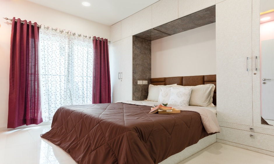 Home interior designers in mumbai where second bedroom has a bed with a leather headboard, a wall to ceiling cabinet