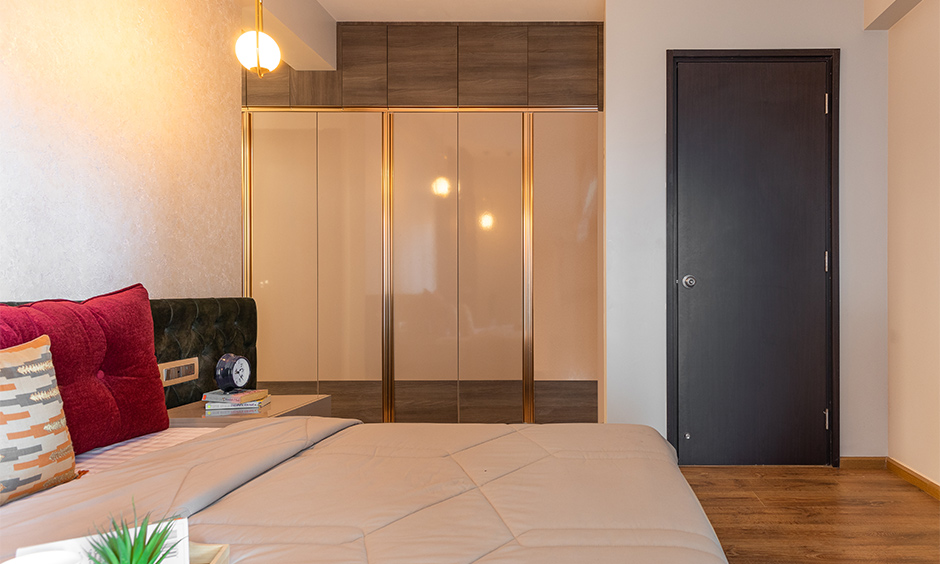 Interior design in mumbai where the master bedroom has a gorgeous beige wardrobe finished in high gloss laminate