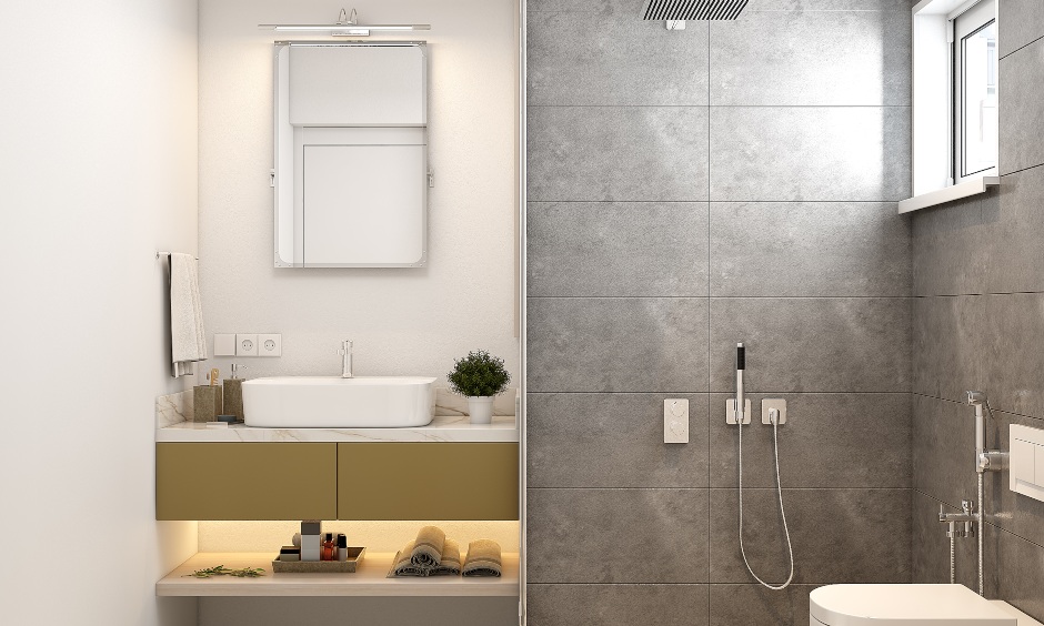 The interior design of 2bhk bathroom has a vanity unit and a glass partition