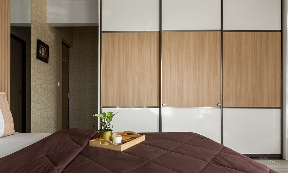 Interior design services in mumbai with master bedroom with a sliding door floor-to-ceiling wardrobe