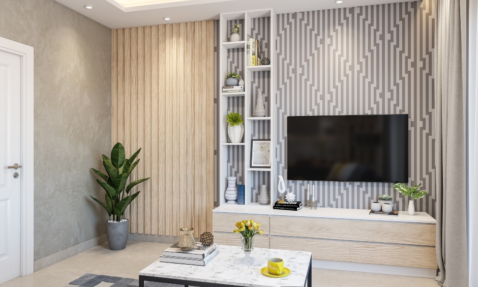 A living room in a 1 bhk home with a low-lying cabinet, a unit with open shelves, and wallpaper accentuate the area's beauty