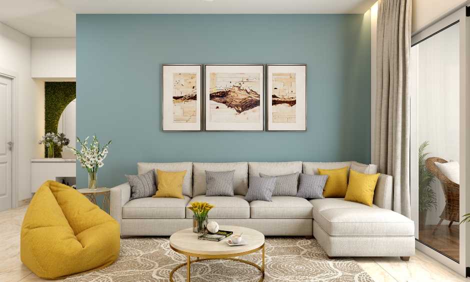 Living room in 1 bhk home design with a sectional sofa and the teal accent wall creates a striking contrast