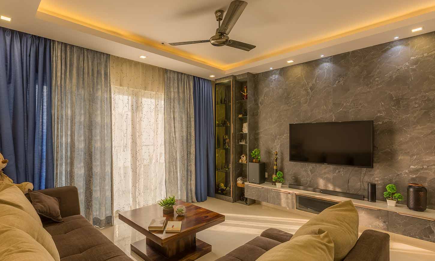 Living room interior design bangalore with a tv unit designed by home interior designers in bangalore