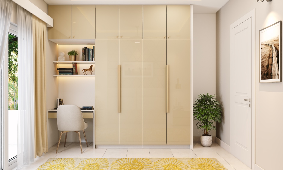 Master bedroom in 2bhk designed with small study nook and floor-to-ceiling wardrobe