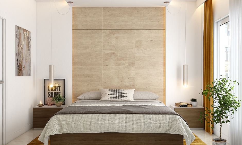Master bedroom in 2bhk home designed with wooden accent wall and two hanging pendant lights.