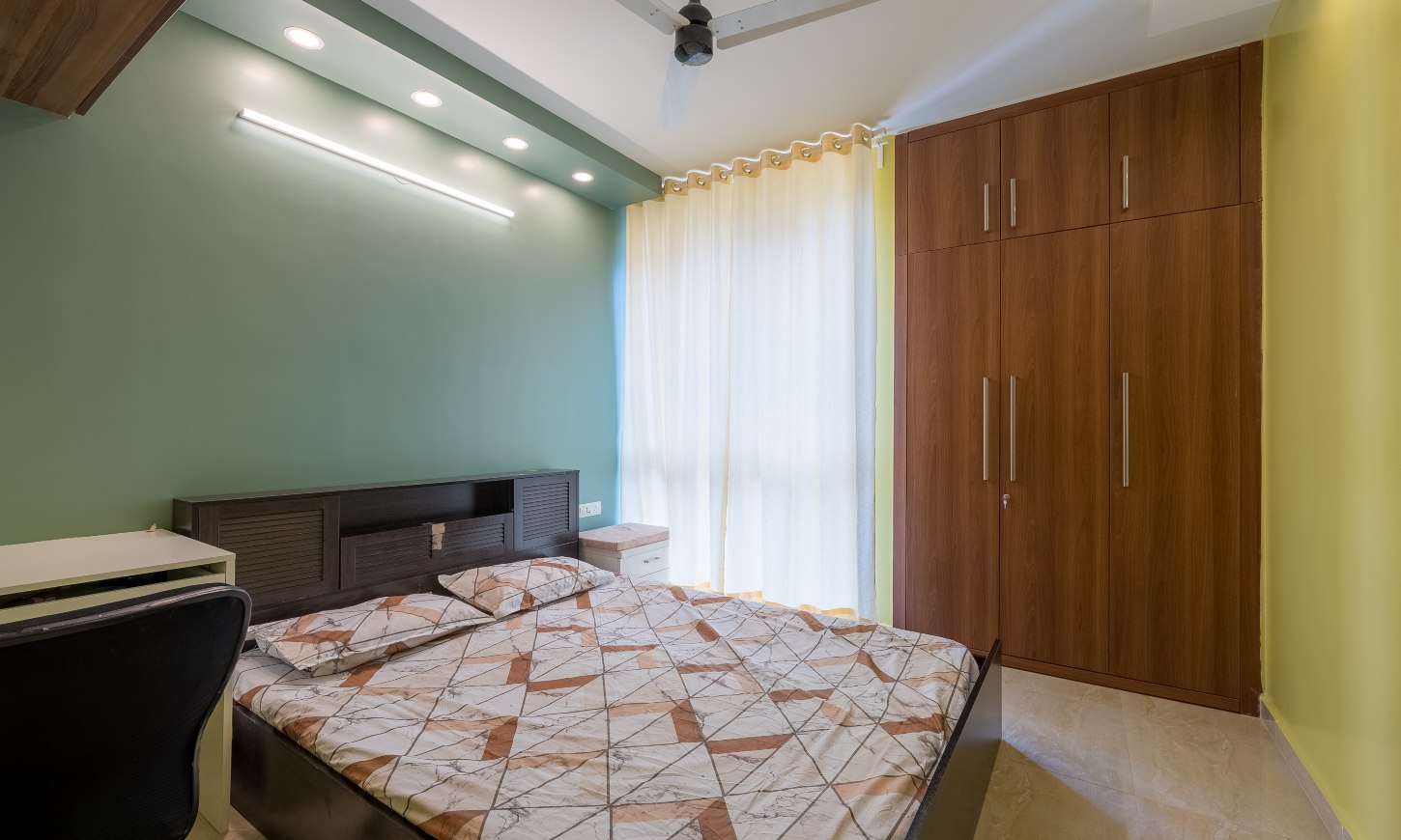 Minimalist bedroom with loft and floor-to-ceiling wardrobe designed for 2 bhk apartment at Sarjapur Road