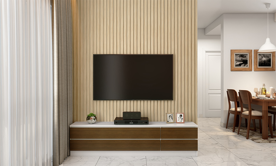 Modern corner TV unit incorporated with a ground-level cabinet for ample storage