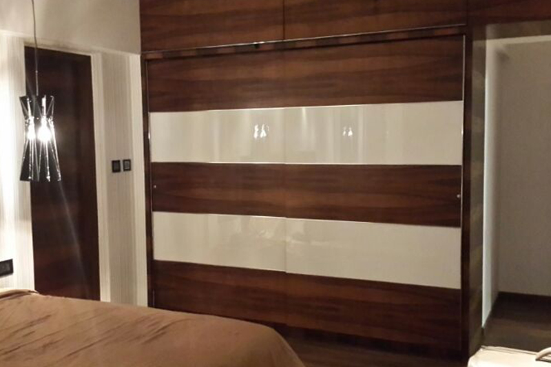 Modern wooden wardrobe designs for bedroom made up of heavy wood covering the whole wall