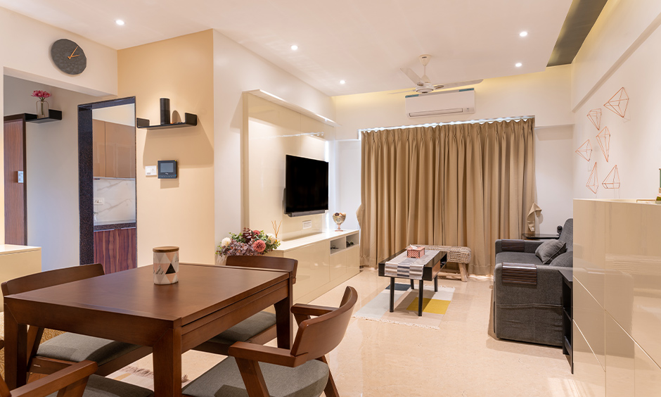 Mumbai apartment interior design designed by design cafe for Living room with tv unit and sofa
