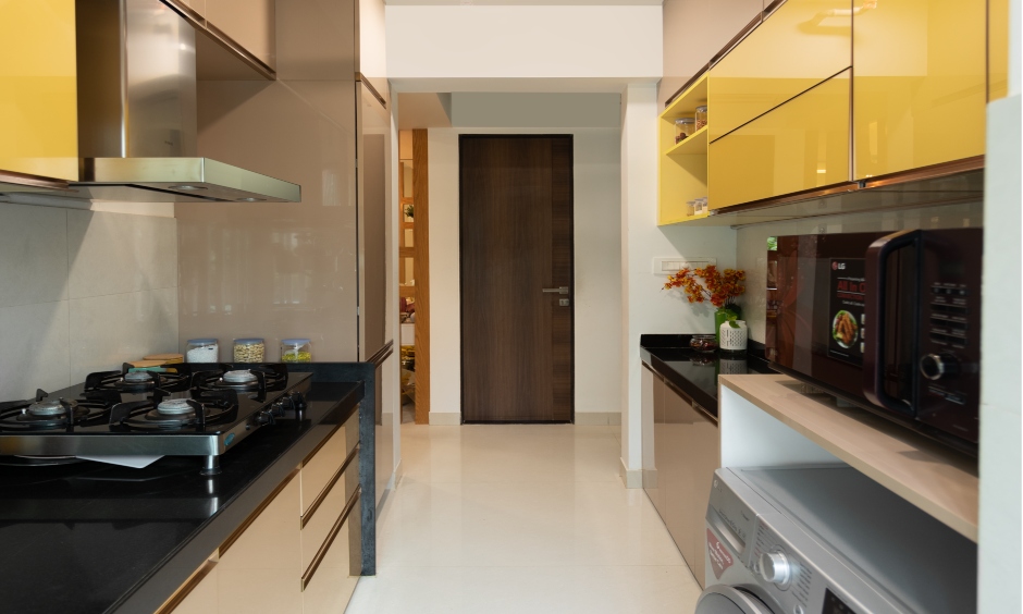 Mumbai flats interior design with a compact parallel kitchen with smart storage solution