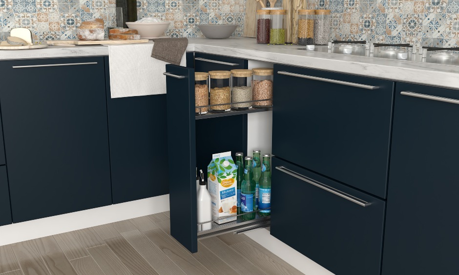 Navy blue and white kitchen design with a oil and spice pull out for storage in kitchen interiors hyderabad