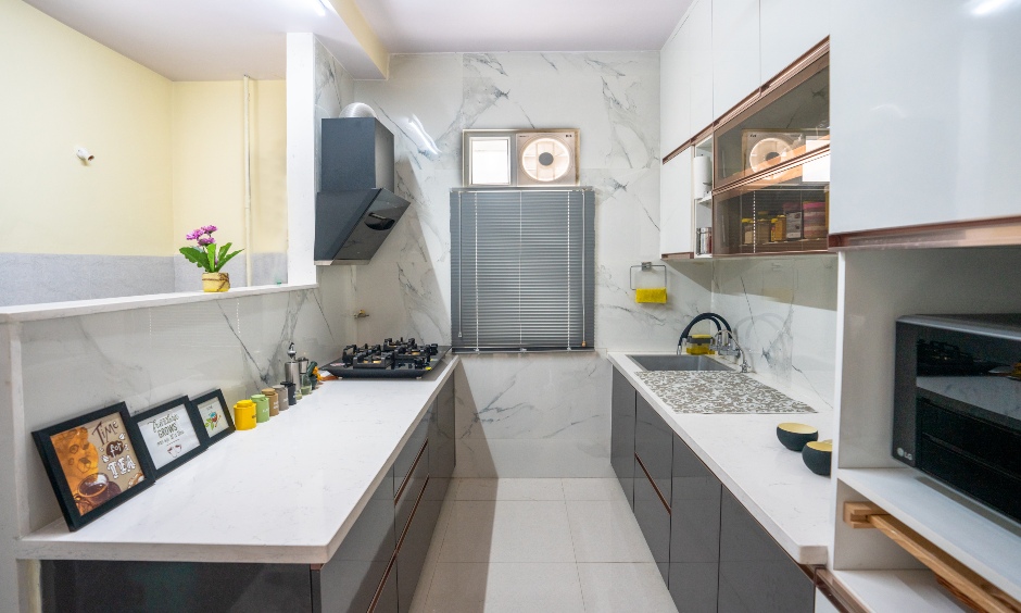 Parallel shaped kitchen designed with haandles storage designed by best interior designers in hyderabad