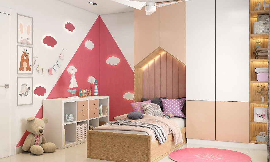Pink and white kids bedroom in 3bhk house designed with a single wooden cot and a wardrobe look chic