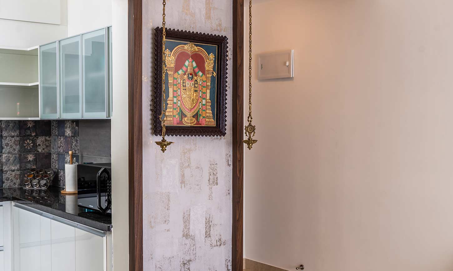 Pooja room design connected to the living room and interior designed by design cafe bangalore