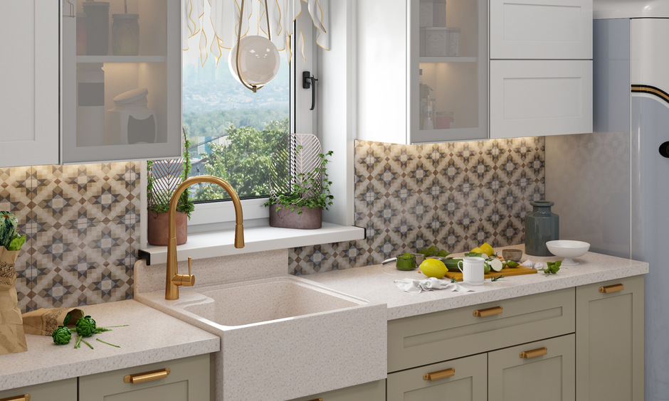 Quartz apron sink in modern kitchen with a golden-accented faucet