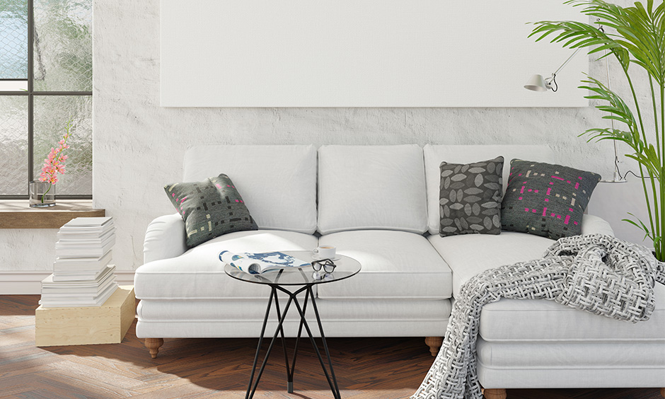 Small room sectional sofa in white coloured with pillows works great for a small family.