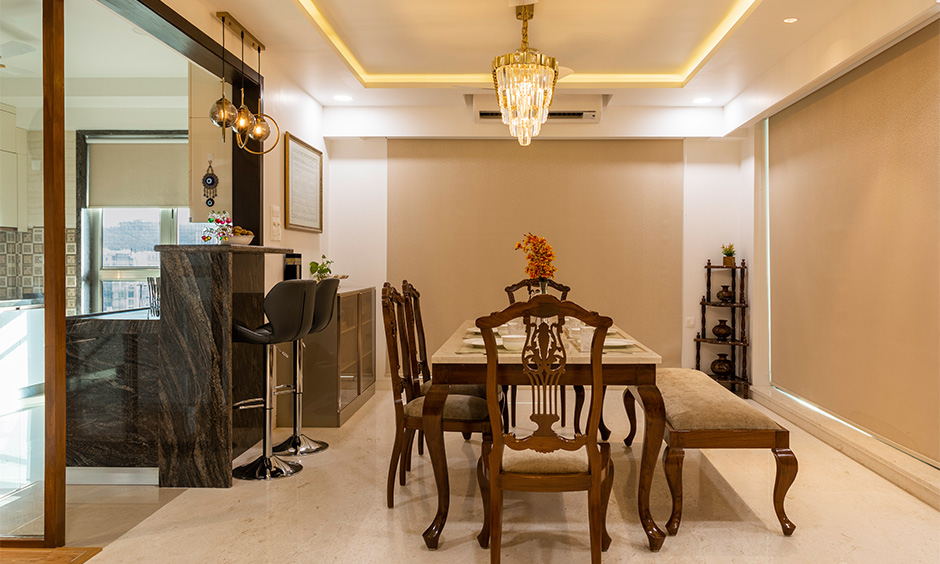 Tall breakfast counter with two bar-style stools created by luxury interior designers in mumbai