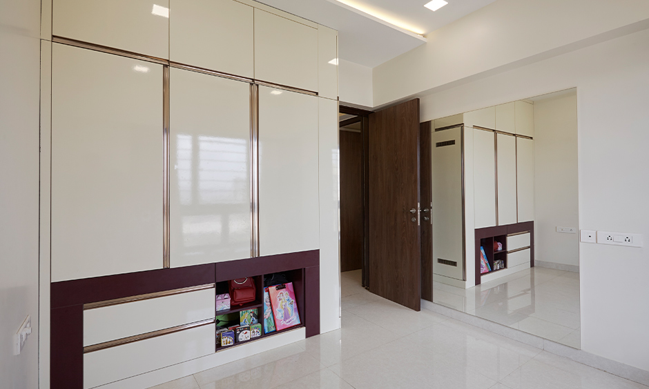 White bedroom with cabinet storage designed by top interior designers in mumbai