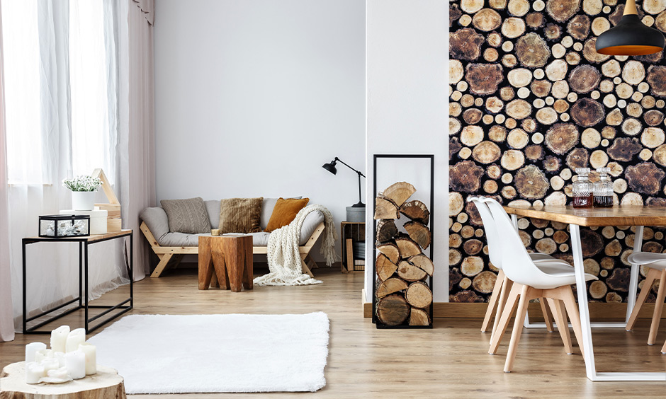 Traditional scandinavian interior design in india with tree stump accessories and the wood-texture wallpaper