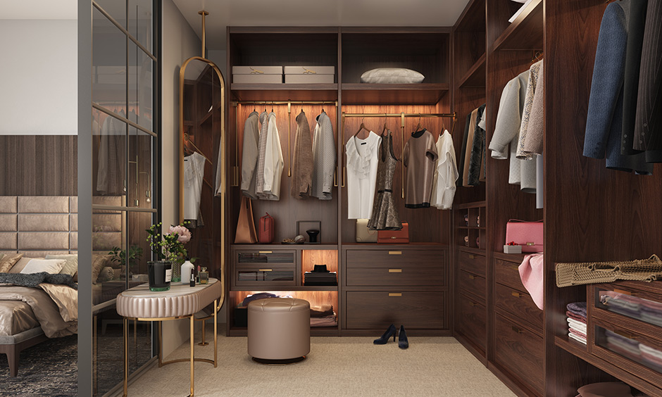Bedroom with walk-in wardrobe is a design reserved for large bedrooms and functions as a dressing area too with chairs.