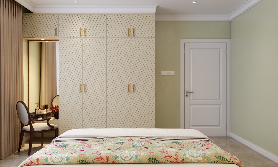 The bedroom has a wardrobe with a concealed dresser unit design in 3bhk home
